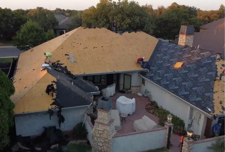 a home with a roof being installed