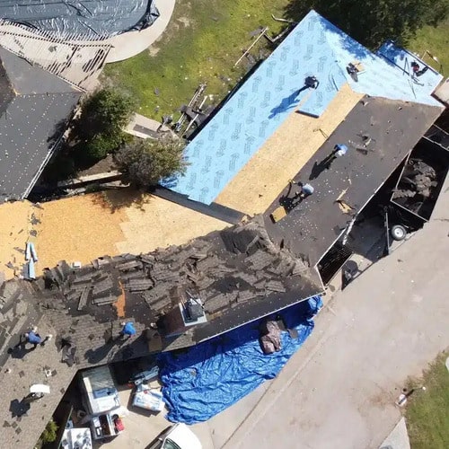 repairs being done on a storm damaged roof